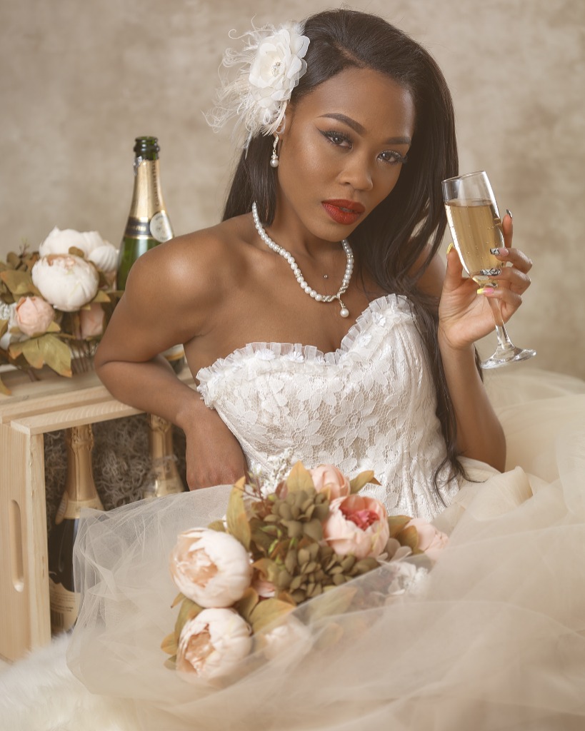 Woman of color  holding champagne in  Bridal Wedding Gown portrait photo taken near Washington DC in Alexandria VA at Portraits by Jared Wolfe